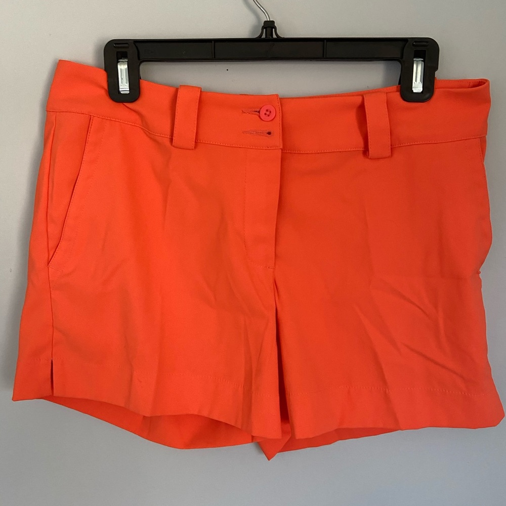 Nike orange golf shorts for women, size 6.